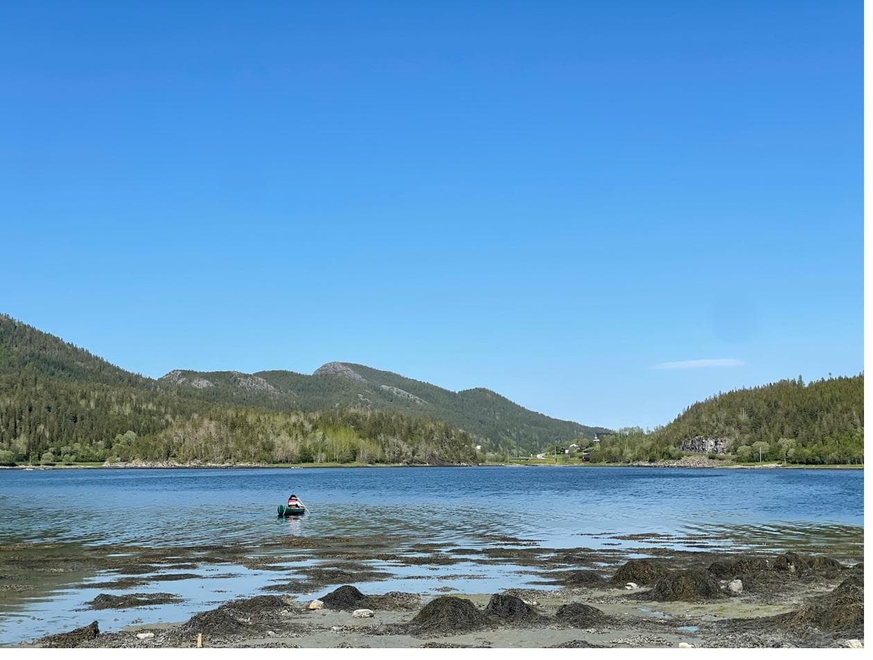 Utsikt over fjorden med en liten båt